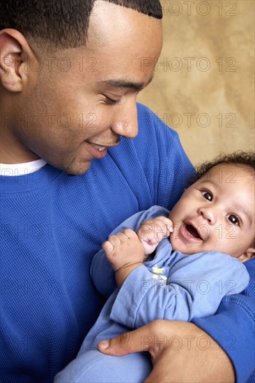 Smiling father holding baby