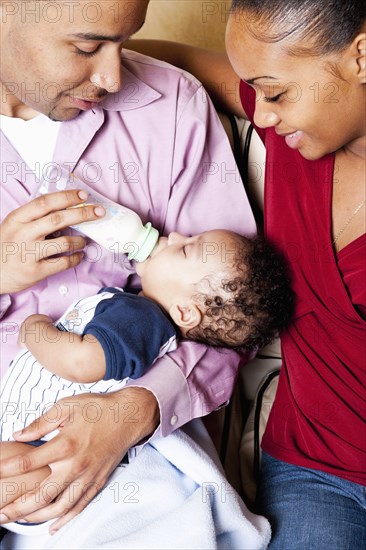 Parents bottle feeding baby