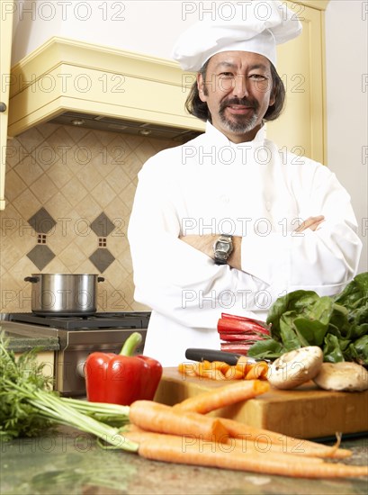 Mixed race chef working in kitchen