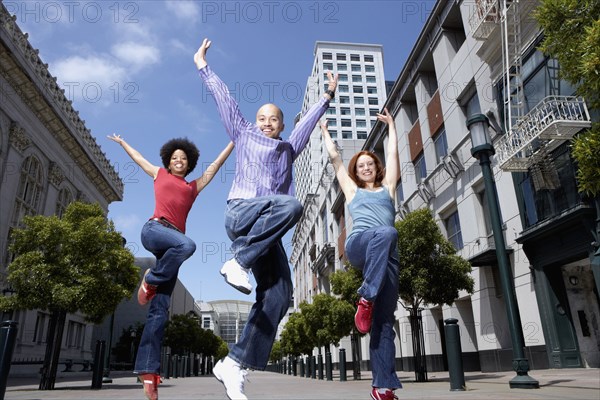 People dancing on city street