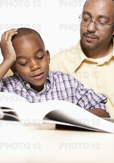 African American father helping son with homework