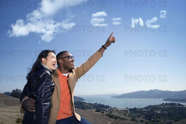 Couple admiring scientific formula in clouds