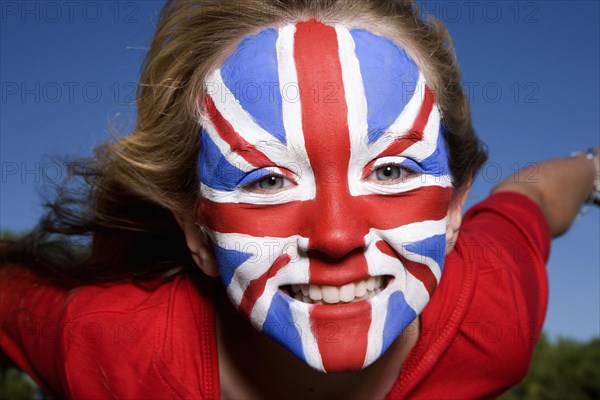 Caucasian girl with United Kingdom flag painted on face