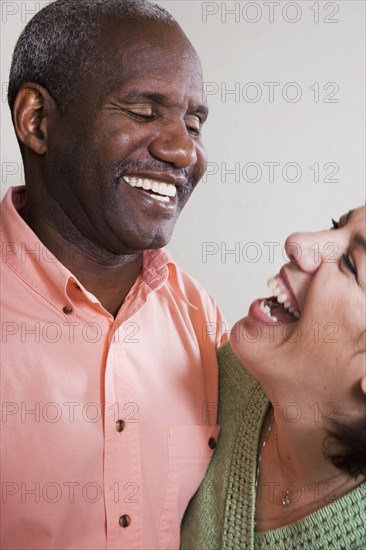 Mixed race couple laughing together