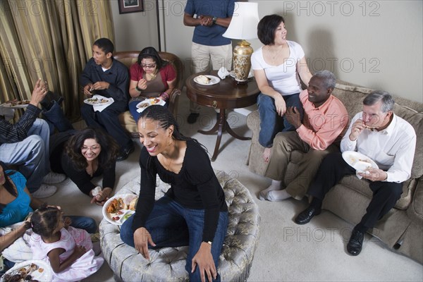 Multi-generation family relaxing together in living room