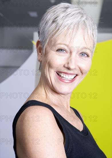 Senior woman smiling in gym