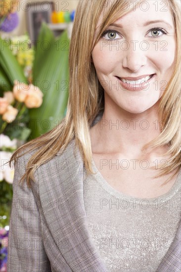 Caucasian businesswoman smiling in florist