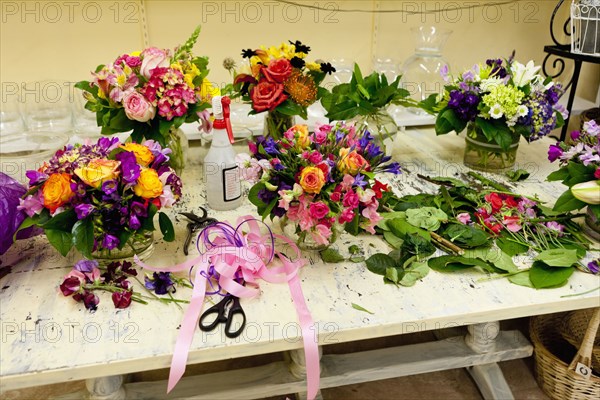 Flower arrangements on work table in florist
