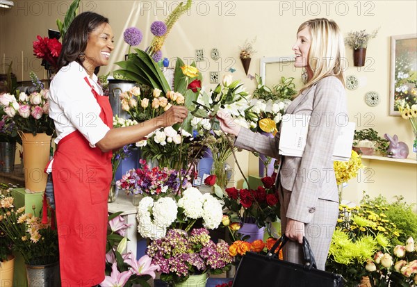 Businesswoman buying flowers at florist