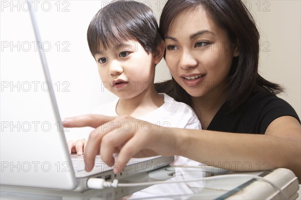Filipino mother and son using laptop together