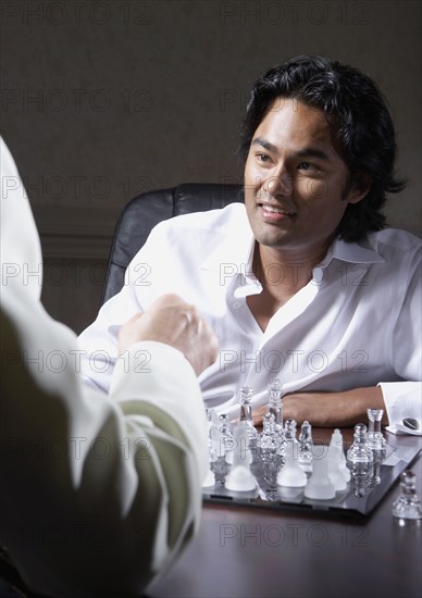 Men playing chess together