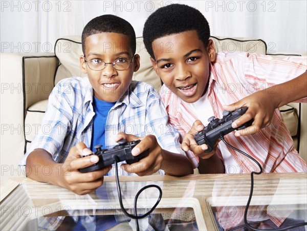 Mixed race boys playing video games