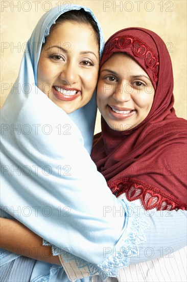 Women in headscarves hugging