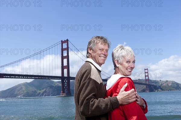 Senior Caucasian couple smiling by Golden Gate Bridge