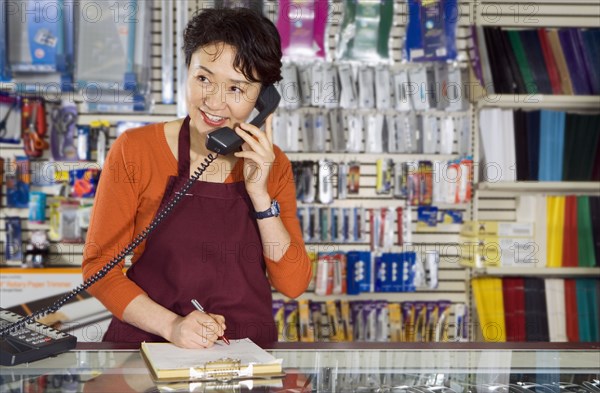 Chinese woman working in office supply store