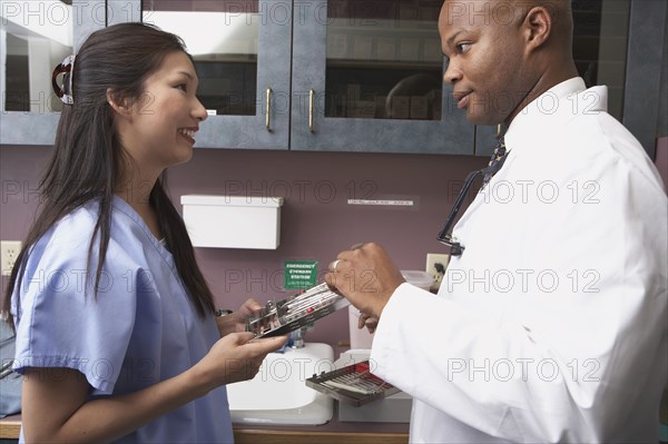 Dentist and nurse talking in office