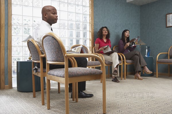 People sitting in dental office waiting room