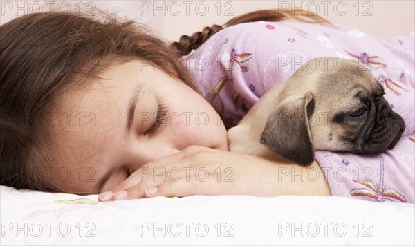 Mixed race girl sleeping with pug