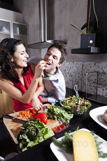 Couple cooking together in kitchen