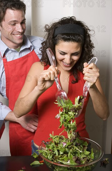 Couple cooking together in kitchen