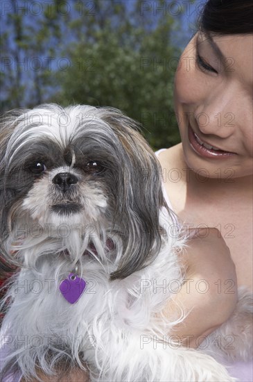 Chinese woman holding dog