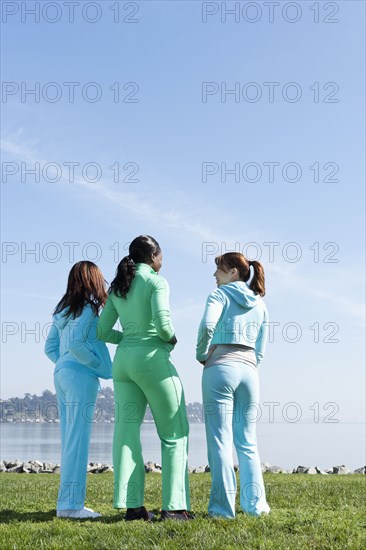 Women standing by rural lake