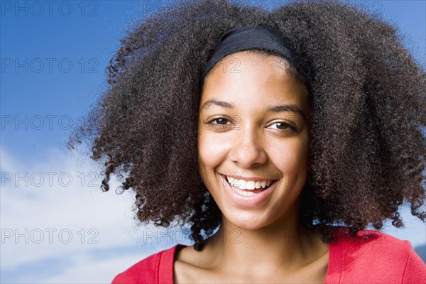 Mixed race teenage girl smiling outdoors