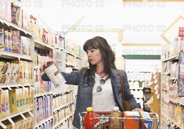 Caucasian woman shopping for groceries in store
