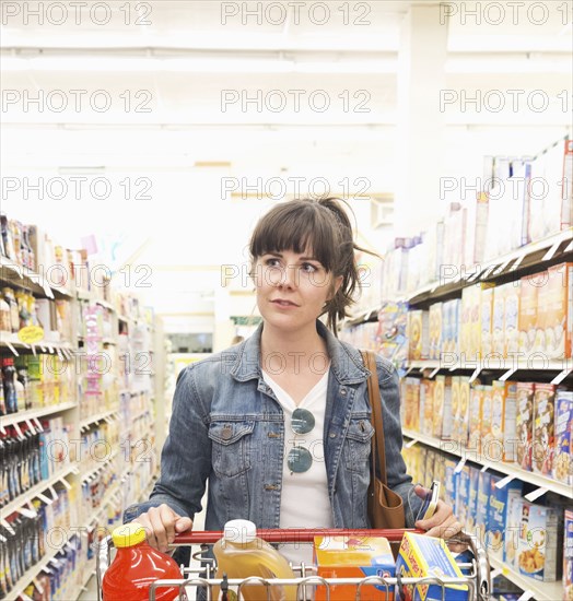 Caucasian woman shopping for groceries in store