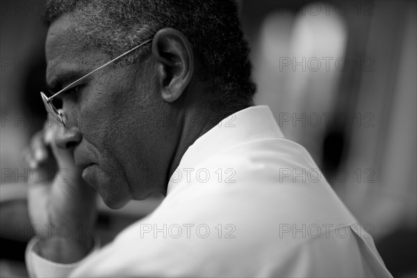 Mixed race businessman looking down