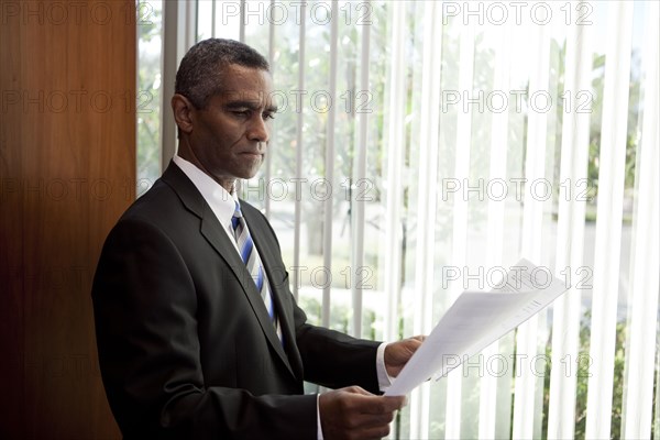 African American businessman looking at paperwork