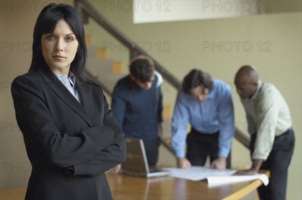 Portrait of businesswoman with coworkers in background