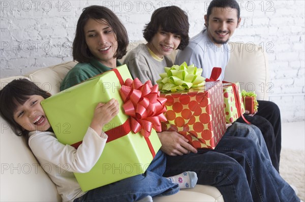 Hispanic family holding gifts