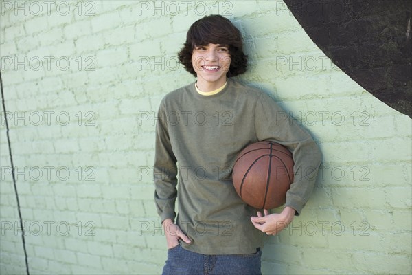 Hispanic boy holding basketball