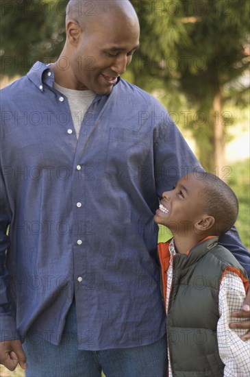 African father and son smiling at each other