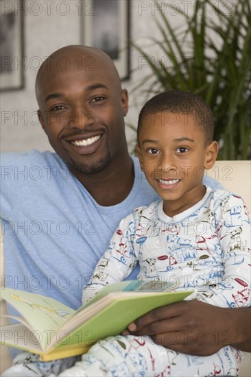 African father and son reading