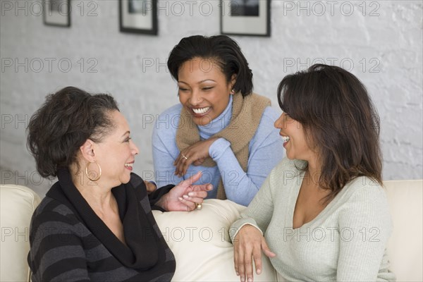 African mother and adult daughters talking