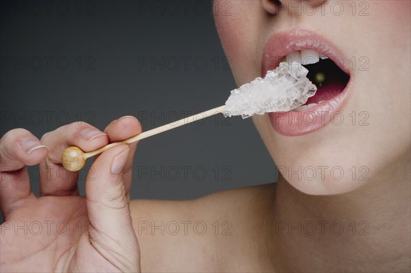 Woman eating rock candy