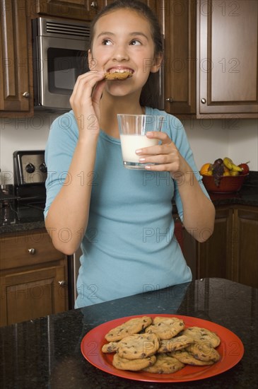 Hispanic girl eating cookies