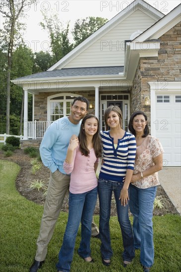 Hispanic family in front of house