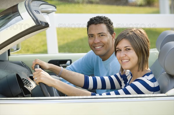 Hispanic father and daughter in car