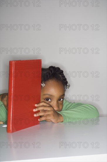 African girl holding book