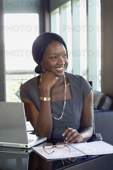 African businesswoman sitting at desk