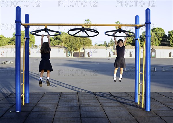 Twin girls playing on playground