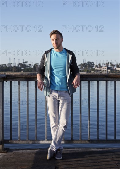 Caucasian man leaning at waterfront