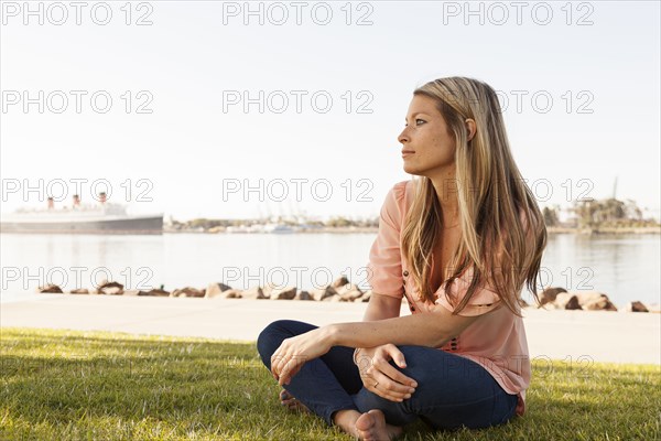 Caucasian woman sitting in park