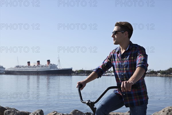 Man riding bicycle at waterfront