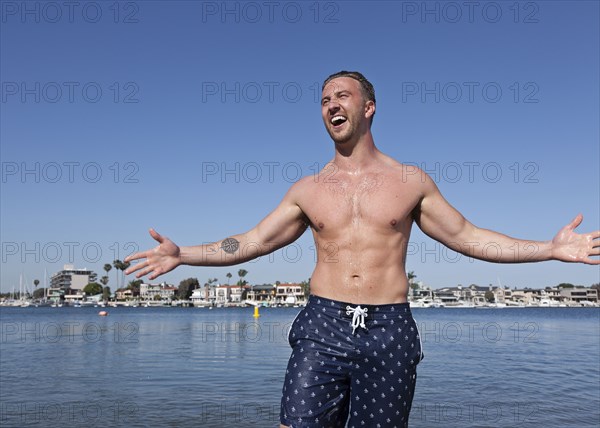 Caucasian man wearing swimsuit on beach
