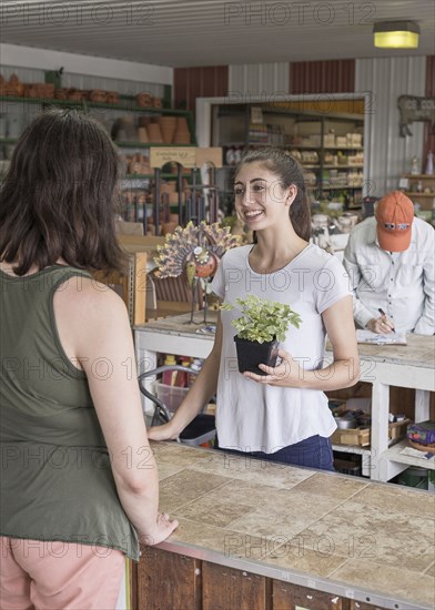 Caucasian mother and daughter talking in store