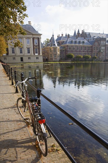 Bicycle and ornate Dutch buildings near pond